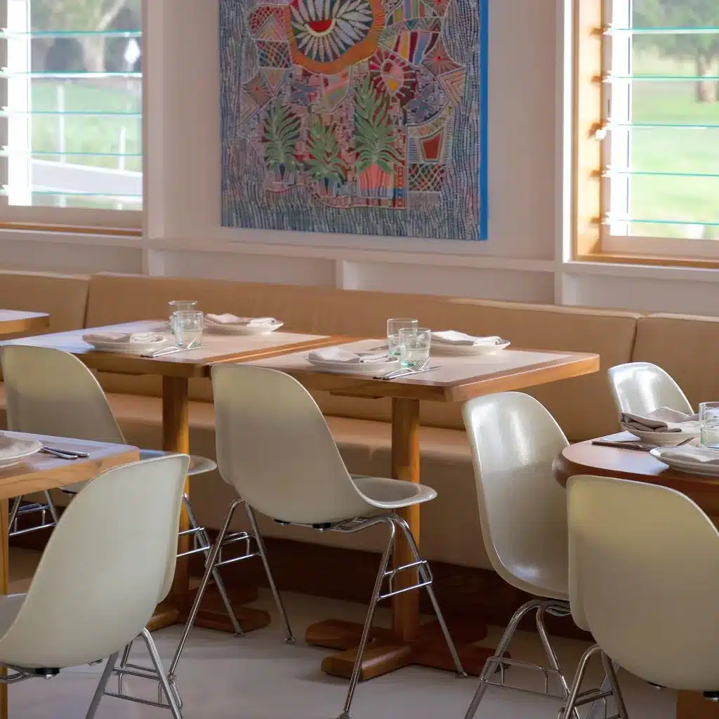 The Joey dining room with set tables and colourful wall art