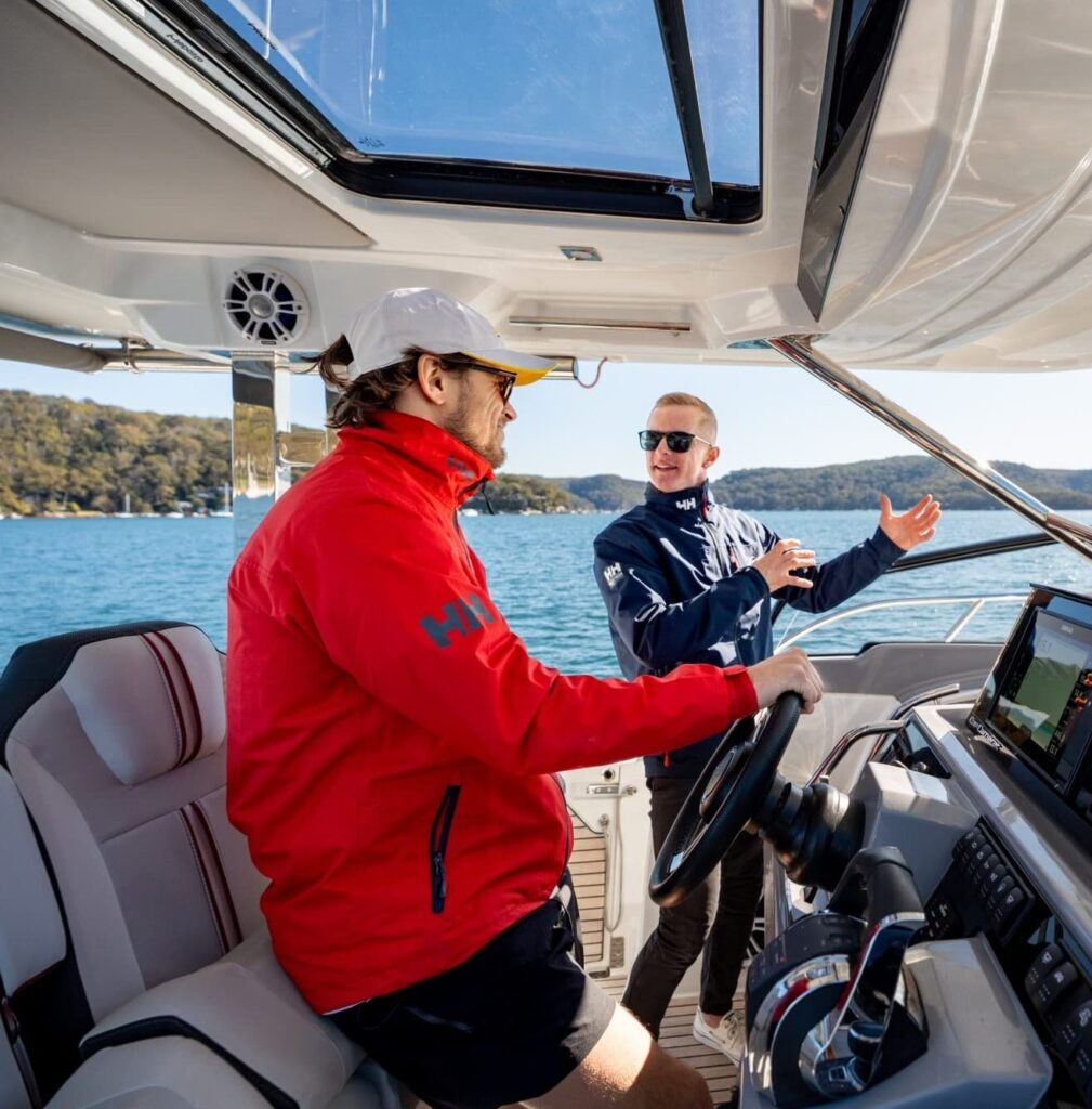 Boat instructor teaching how to dock a boat using throttle and steering controls
