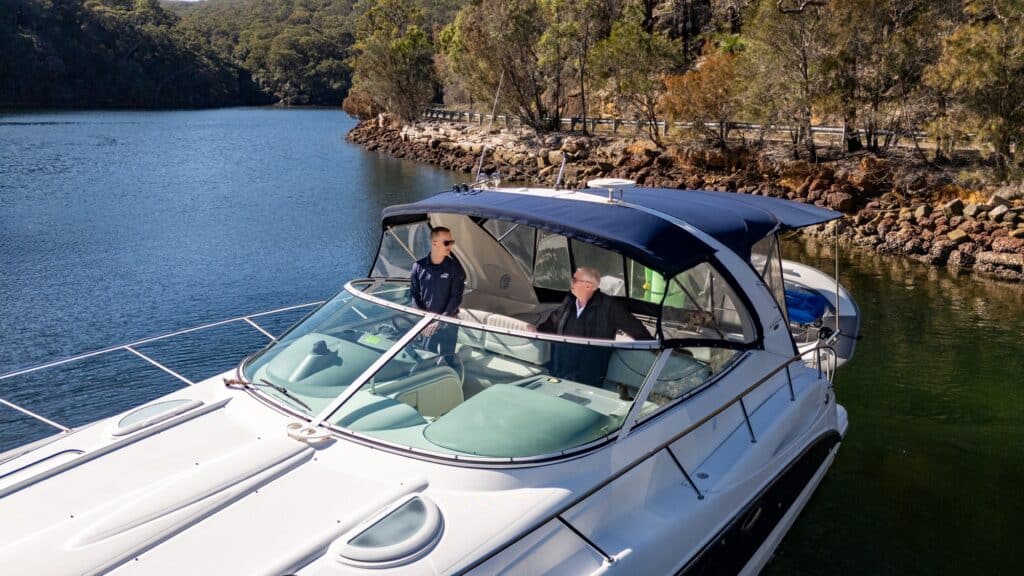 Tristian Mooney coaching a client while docking a motorboat at Akuna Bay