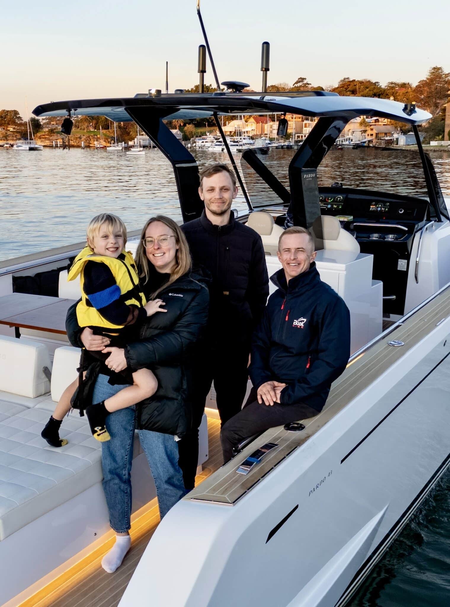 Family and crew smiling on a Pardo luxury motorboat