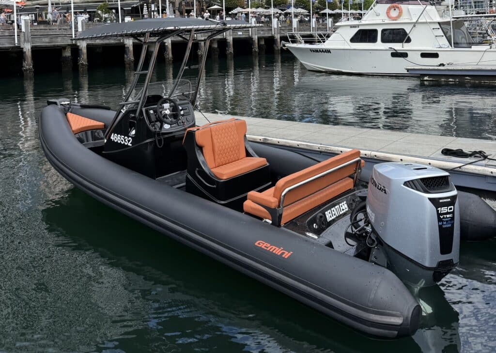 Gemini Relentless RIB boat with tan leather seats at marina