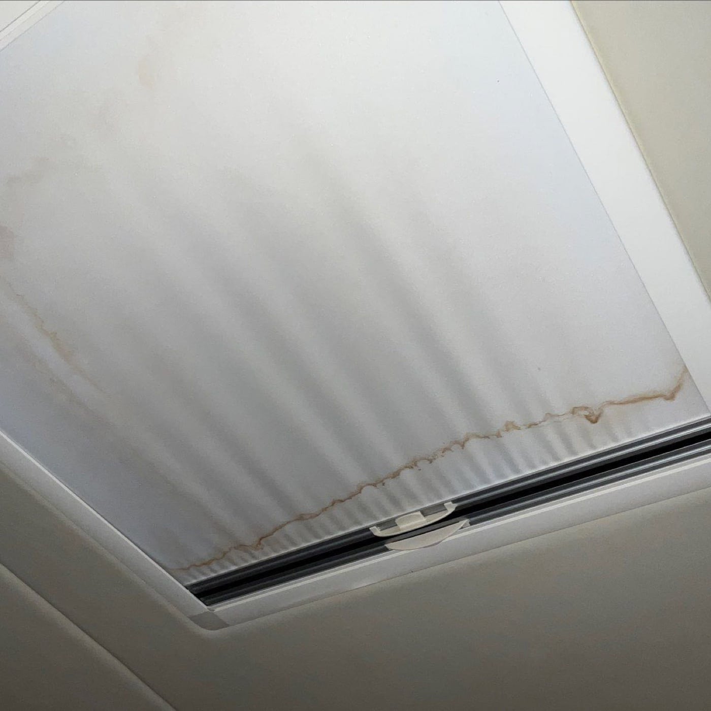 Brown water staining around the inside of a boat hatch